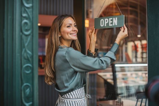 Woman flipping Open sign