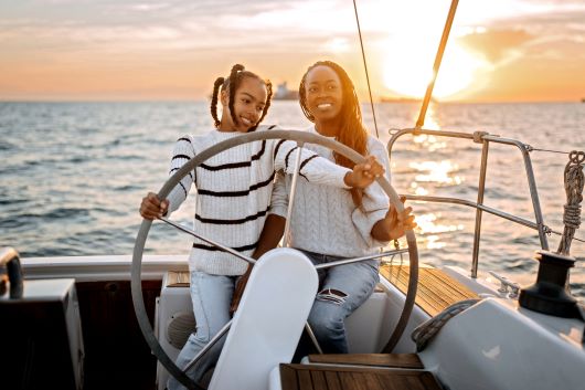 Mother and daughter steering a boat
