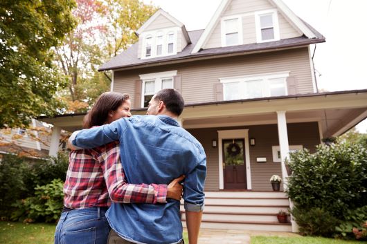 Man and woman walking up to house